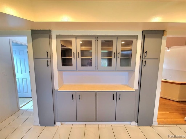 28142 Liberty Dr, Warren, MI 48092 - kitchen featuring gray cabinets, light countertops, and glass insert cabinets