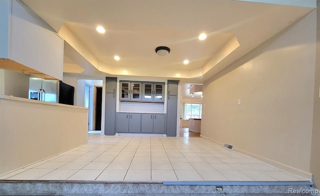 28142 Liberty Dr, Warren, MI 48092 - foyer with a raised ceiling, recessed lighting, light tile patterned floors, and baseboards