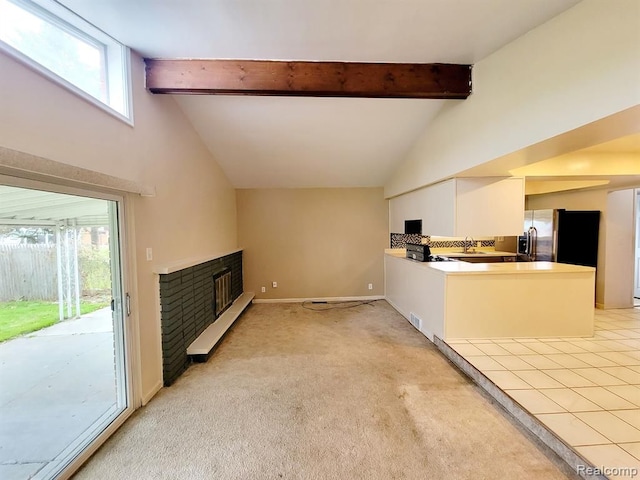 28142 Liberty Dr, Warren, MI 48092 - unfurnished living room with high vaulted ceiling, a brick fireplace, healthy amount of natural light, beamed ceiling, and baseboards