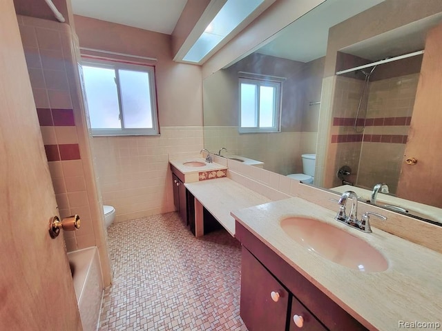 28142 Liberty Dr, Warren, MI 48092 - bathroom featuring toilet, tile walls, vanity, and wainscoting