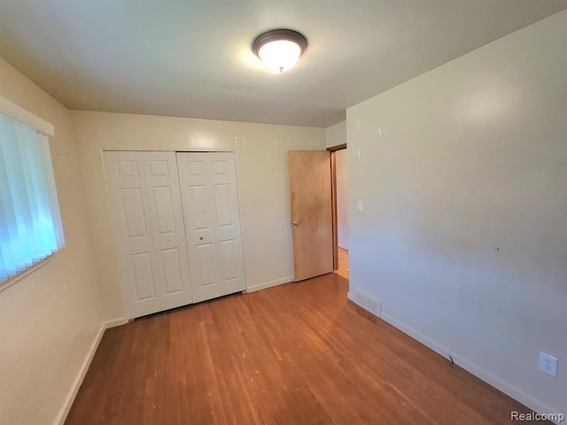 28142 Liberty Dr, Warren, MI 48092 - unfurnished bedroom with wood finished floors, baseboards, and a closet