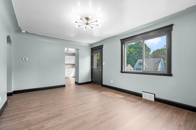 137 Wiltshire Ave, Battle Creek, MI 49015 - empty room with a chandelier and light wood-style floors