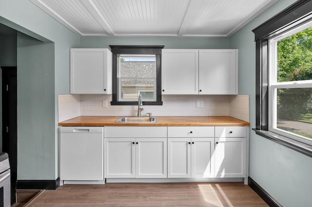 137 Wiltshire Ave, Battle Creek, MI 49015 - kitchen with butcher block counters, white dishwasher, white cabinetry, and tasteful backsplash