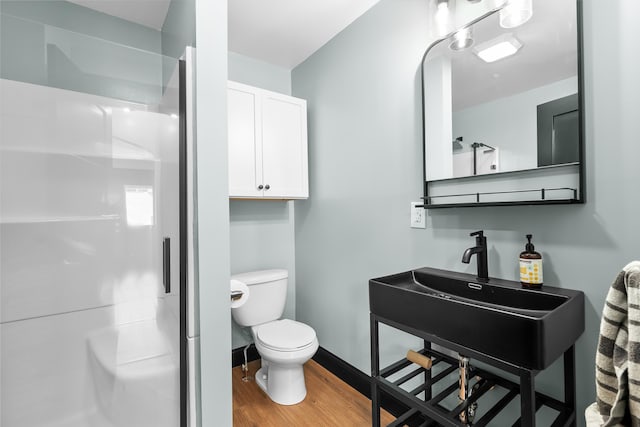 137 Wiltshire Ave, Battle Creek, MI 49015 - full bathroom featuring wood finished floors, a shower stall, and vanity