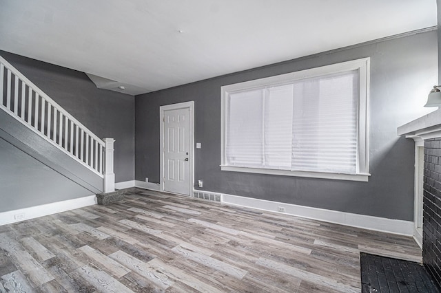 208 Hill St, Highland Park, MI 48203 - unfurnished living room with stairs, wood finished floors, and baseboards
