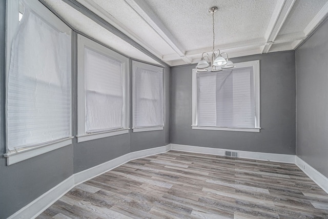 208 Hill St, Highland Park, MI 48203 - empty room featuring a chandelier, wood finished floors, a textured ceiling, and baseboards