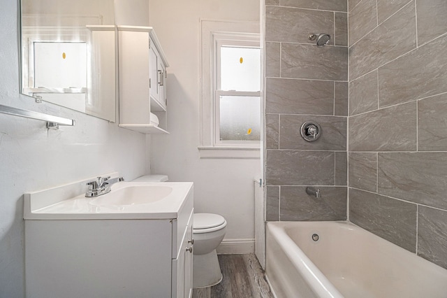 208 Hill St, Highland Park, MI 48203 - bathroom with wood finished floors, toilet, vanity, bathing tub / shower combination, and baseboards