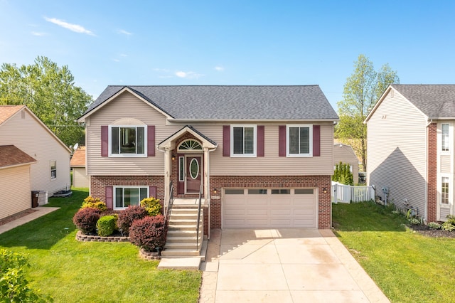 4127 Stone Post Rd, Newport, MI 48166 - bi-level home with brick siding, an attached garage, concrete driveway, and roof with shingles