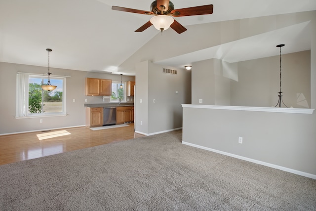 4127 Stone Post Rd, Newport, MI 48166 - unfurnished living room featuring light colored carpet, a ceiling fan, baseboards, vaulted ceiling, and a sink