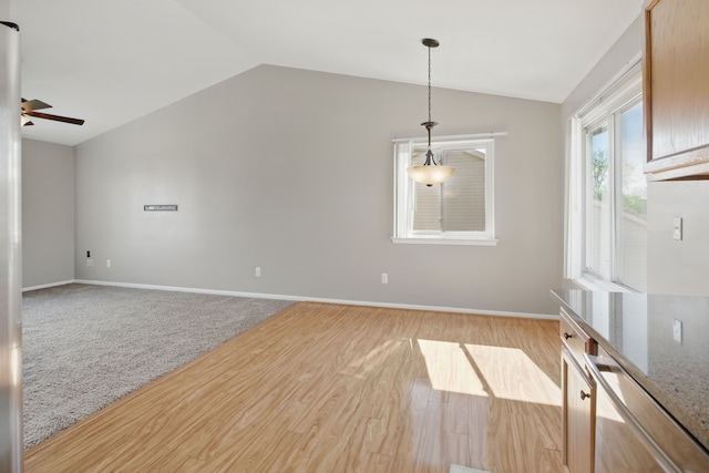 4127 Stone Post Rd, Newport, MI 48166 - spare room featuring lofted ceiling, ceiling fan, light wood-style floors, and baseboards