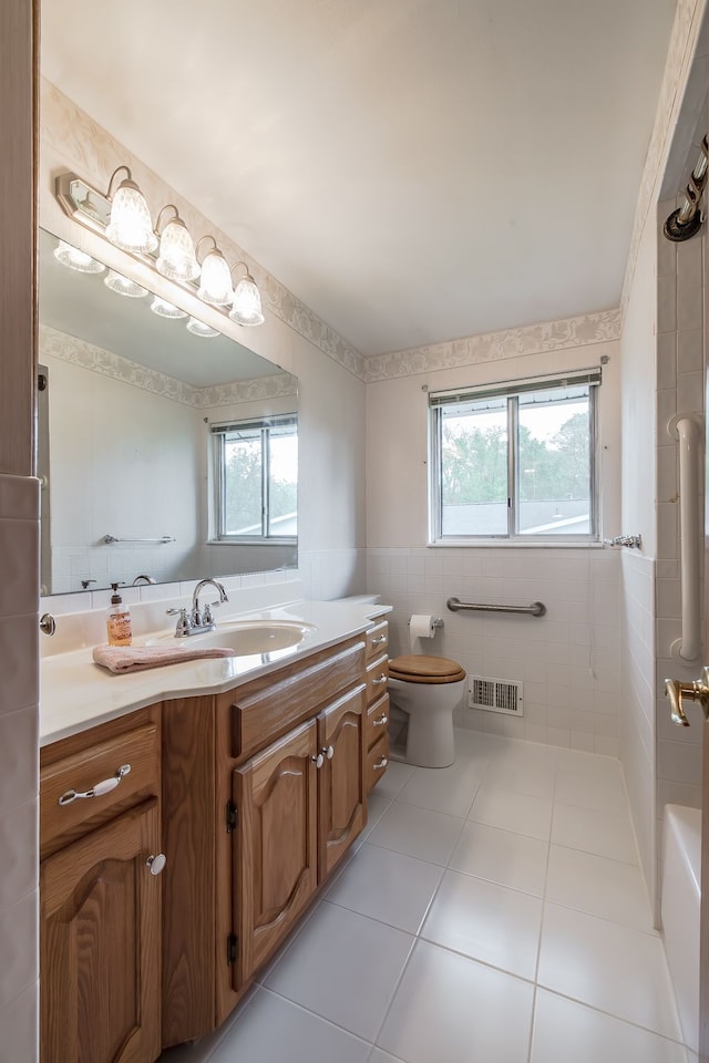 841 Driburg Dr, Commerce Twp, MI 48390 - bathroom with tile walls, plenty of natural light, tile patterned floors, toilet, and vanity