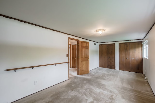841 Driburg Dr, Commerce Twp, MI 48390 - unfurnished bedroom featuring two closets and carpet floors