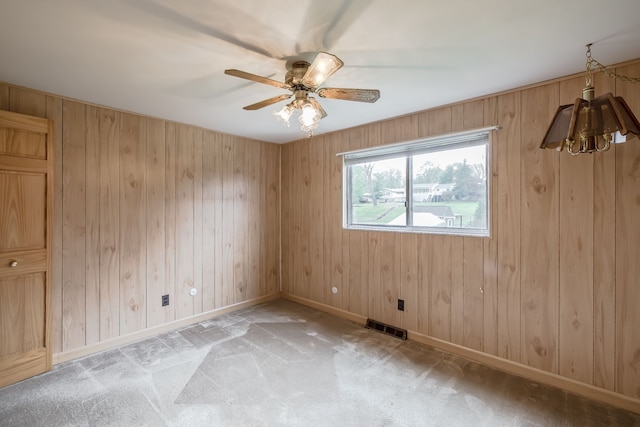 841 Driburg Dr, Commerce Twp, MI 48390 - unfurnished room featuring baseboards, ceiling fan, light colored carpet, and wood walls