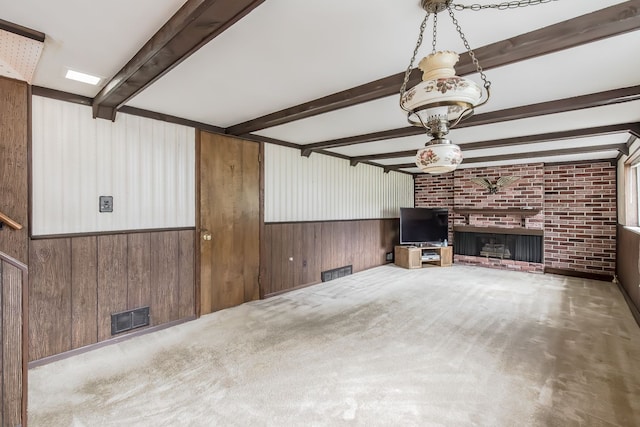 841 Driburg Dr, Commerce Twp, MI 48390 - unfurnished living room with wood walls, beamed ceiling, a fireplace, brick wall, and carpet