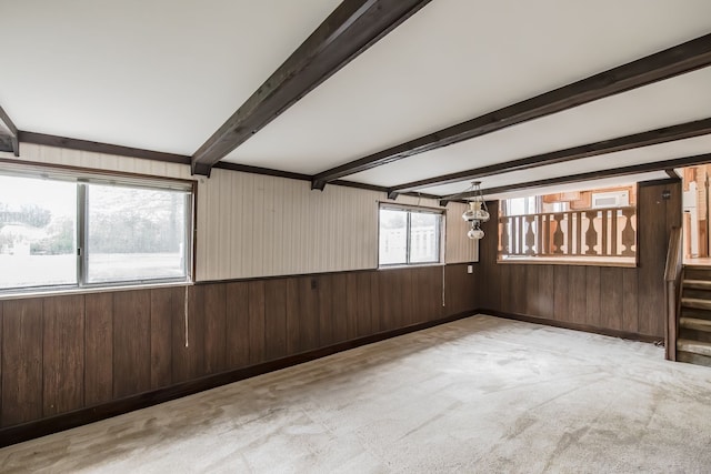 841 Driburg Dr, Commerce Twp, MI 48390 - spare room with wooden walls, carpet floors, beamed ceiling, and stairs