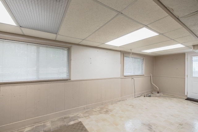 841 Driburg Dr, Commerce Twp, MI 48390 - unfurnished room with tile patterned floors, a drop ceiling, and wood walls