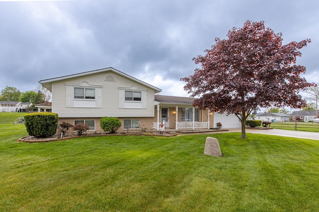 841 Driburg Dr, Commerce Twp, MI 48390 - split level home featuring driveway, a porch, a garage, and a front lawn