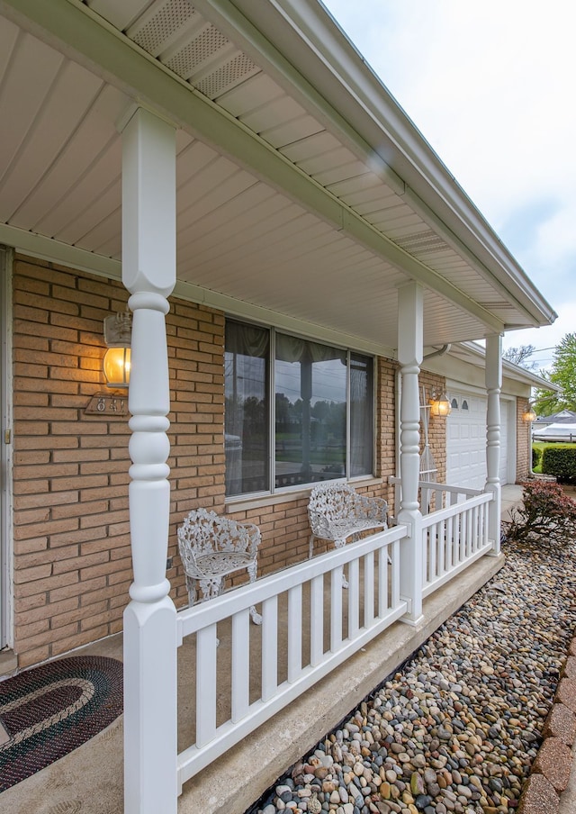 841 Driburg Dr, Commerce Twp, MI 48390 - property entrance with covered porch, brick siding, driveway, and an attached garage