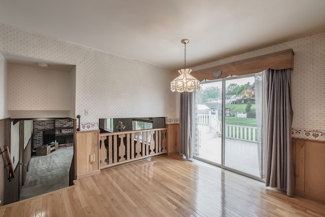 841 Driburg Dr, Commerce Twp, MI 48390 - dining space featuring wallpapered walls, a chandelier, and wood finished floors