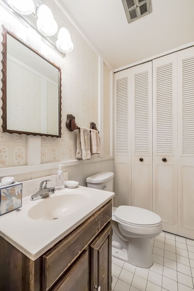 841 Driburg Dr, Commerce Twp, MI 48390 - bathroom featuring tile patterned floors, toilet, a closet, wallpapered walls, and vanity