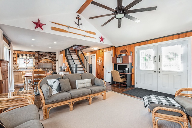 1107 E Lincoln Ave, Royal Oak, MI 48067 - living area with wooden walls, a ceiling fan, stairs, french doors, and beam ceiling