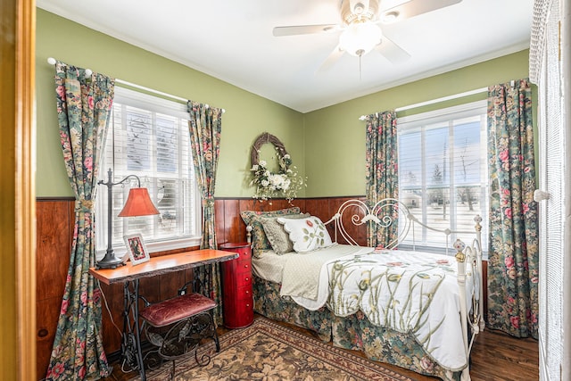 1107 E Lincoln Ave, Royal Oak, MI 48067 - bedroom with a wainscoted wall, wood finished floors, and a ceiling fan