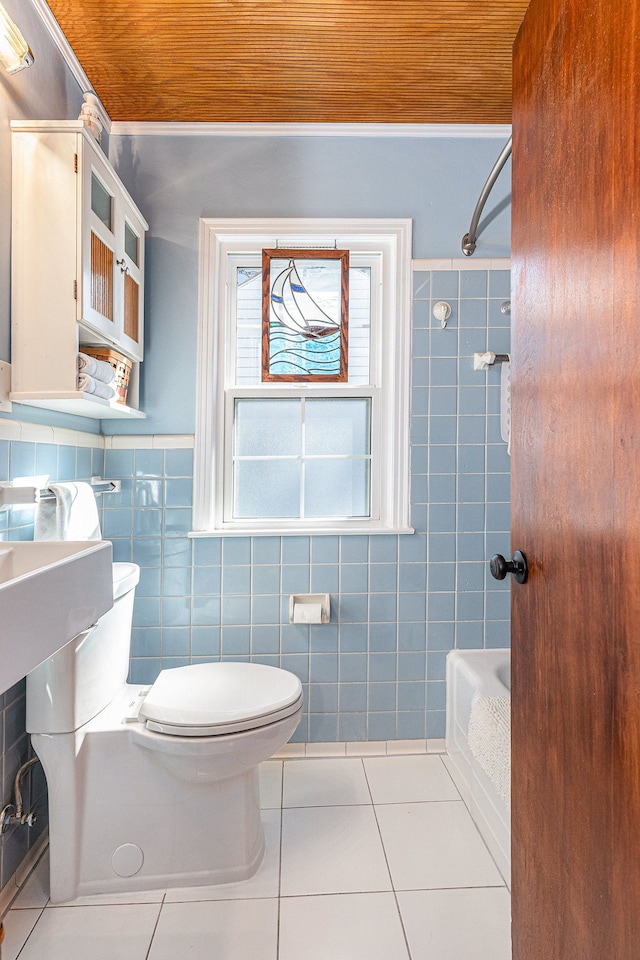 1107 E Lincoln Ave, Royal Oak, MI 48067 - full bath featuring tile walls, tile patterned floors, toilet, shower / bathtub combination, and a wainscoted wall