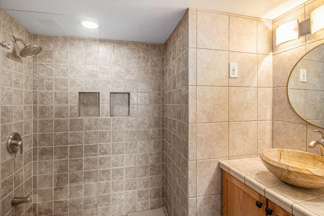 555 E William St Unit 25J, Ann Arbor, MI 48104 - full bathroom with tiled shower, vanity, and tile walls