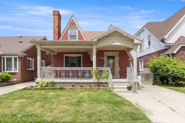10436 Bertram St, Dearborn, MI 48126 - view of front of home with covered porch, brick siding, a chimney, and a front yard