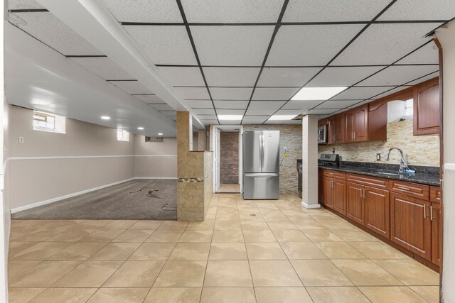 10436 Bertram St, Dearborn, MI 48126 - kitchen featuring stainless steel appliances, a sink, baseboards, dark stone counters, and a drop ceiling