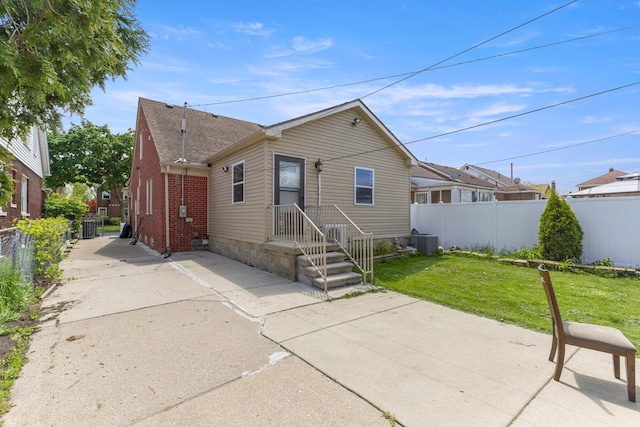 10436 Bertram St, Dearborn, MI 48126 - view of front facade with cooling unit, a patio area, and a shingled roof