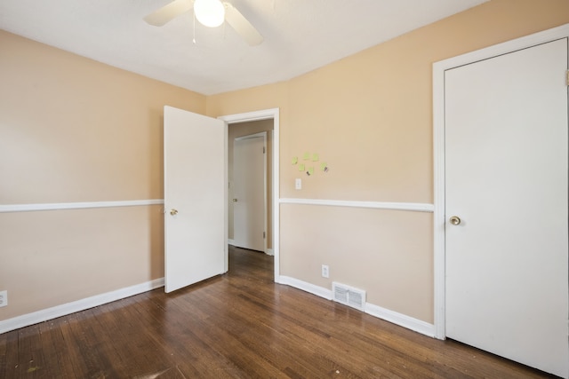 unfurnished bedroom with wood finished floors, baseboards, and ceiling fan