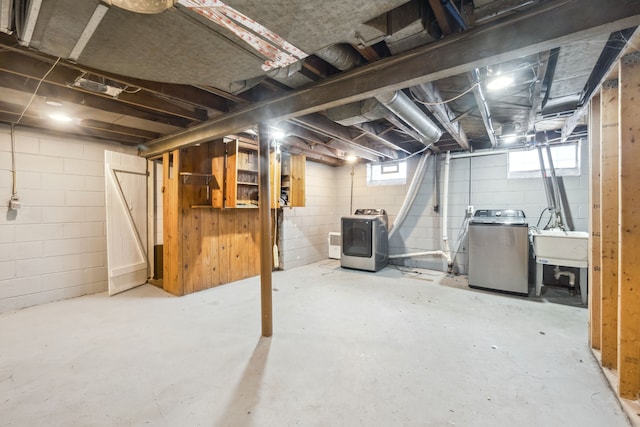 basement with washer / clothes dryer and a sink