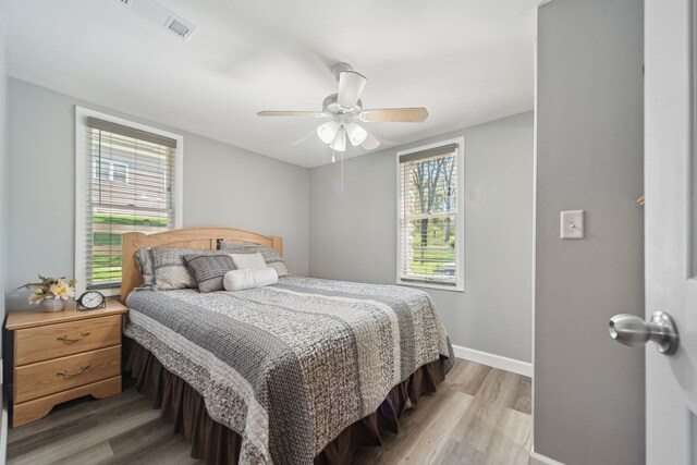5780 Elvira, Pinckney, MI 48169 - bedroom featuring light wood-type flooring, baseboards, and a ceiling fan