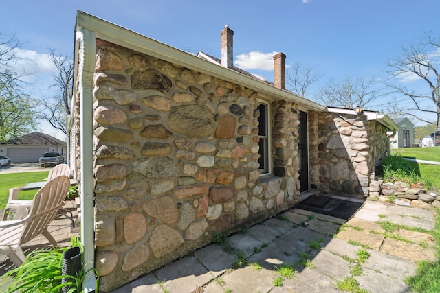 5780 Elvira, Pinckney, MI 48169 - view of side of home featuring stone siding