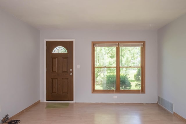 entrance foyer featuring light wood finished floors and baseboards