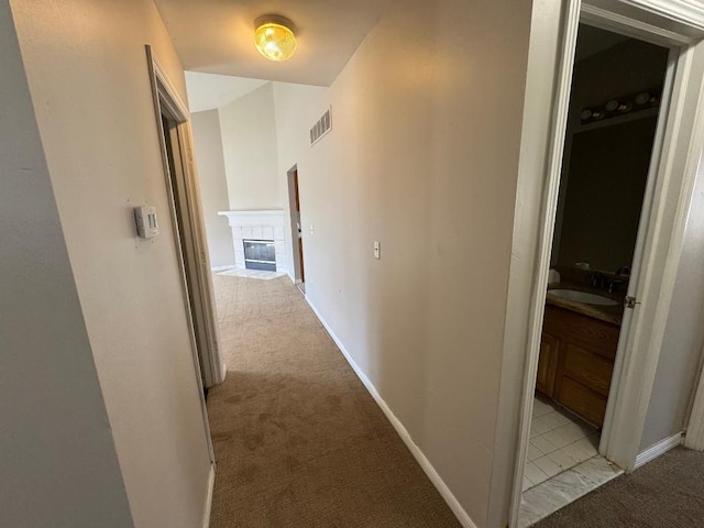 22031 Laurel St, Clinton Township, MI 48035 - corridor featuring light carpet, a sink, and baseboards