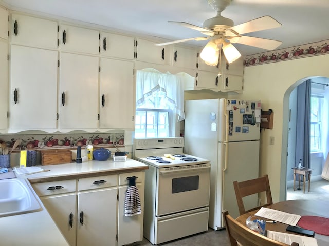 399 E Vermont Ave, White Pigeon, MI 49099 - kitchen with white appliances, arched walkways, a ceiling fan, a sink, and light countertops