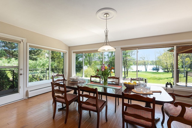 6305 N Shore Ct, West Bloomfield, MI 48324 - dining area featuring a water view, plenty of natural light, hardwood / wood-style flooring, vaulted ceiling, and a baseboard heating unit