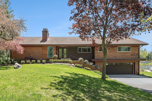6305 N Shore Ct, West Bloomfield, MI 48324 - single story home with french doors, driveway, a garage, a chimney, and a front lawn