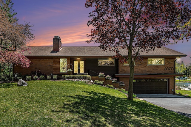 6305 N Shore Ct, West Bloomfield, MI 48324 - view of front facade with driveway, a chimney, a garage, and a lawn