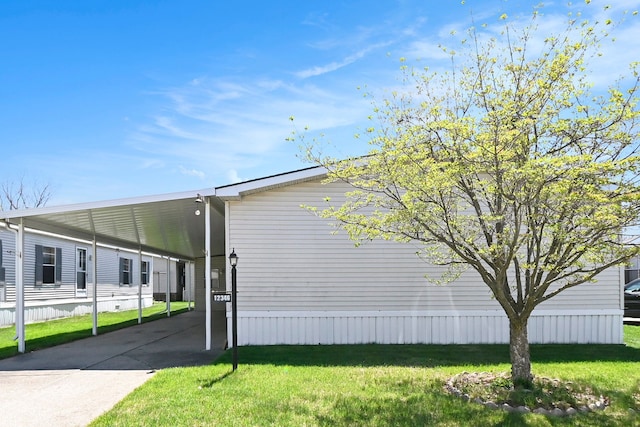 12346 Quail Ct, Shelby Twp, MI 48315 - view of property exterior featuring a carport, a lawn, and concrete driveway