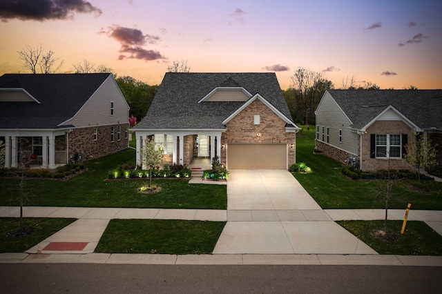 4814 Cranston Rd Unit 86, Canton, MI 48188 - traditional home featuring a front yard, an attached garage, concrete driveway, and brick siding