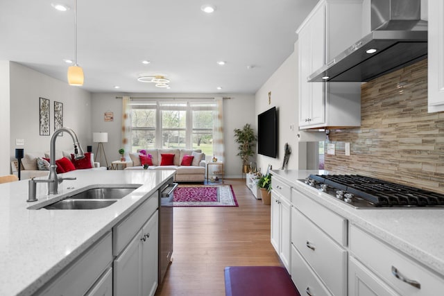 4814 Cranston Rd Unit 86, Canton, MI 48188 - kitchen with wall chimney range hood, a sink, appliances with stainless steel finishes, open floor plan, and recessed lighting