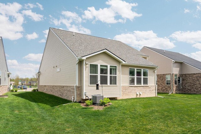4814 Cranston Rd Unit 86, Canton, MI 48188 - rear view of house with a yard, brick siding, and roof with shingles