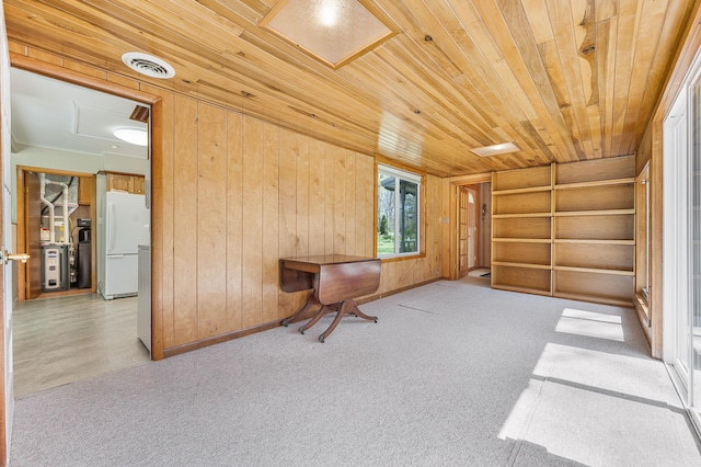 8607 Cochise Ct, Howard City, MI 49329 - sitting room with wood walls, wood ceiling, carpet flooring, built in features, and attic access
