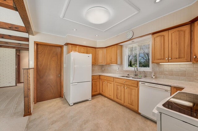 8607 Cochise Ct, Howard City, MI 49329 - kitchen with white appliances, a sink, light countertops, backsplash, and light colored carpet