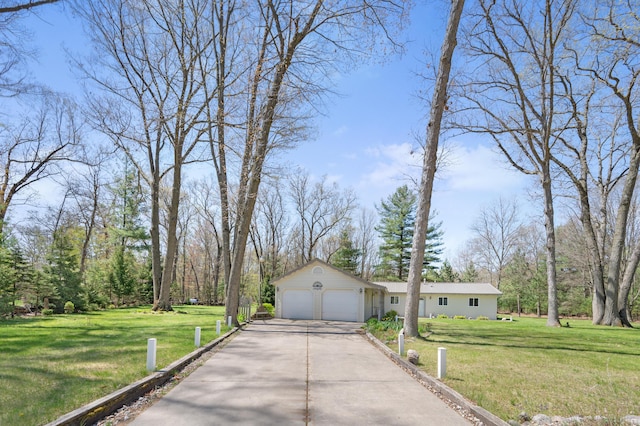 8607 Cochise Ct, Howard City, MI 49329 - view of front of house with driveway, a front yard, and an attached garage