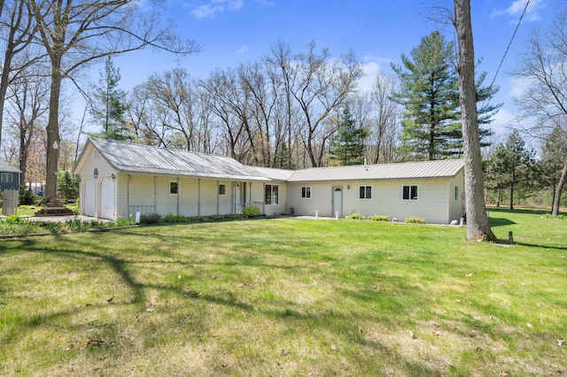 8607 Cochise Ct, Howard City, MI 49329 - back of property with metal roof and a lawn