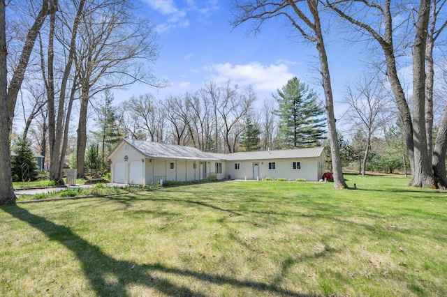 8607 Cochise Ct, Howard City, MI 49329 - rear view of house with a garage and a yard